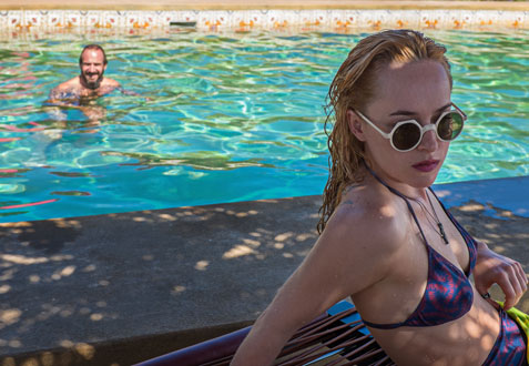 Ralph Fiennes as “Harry Hawkes” and Dakota Johnson as “Penelope Lanier” in A BIGGER SPLASH. Photo courtesy of Fox Searchlight Pictures. © 2015 Twentieth Century Fox Film Corporation All Rights Reserved