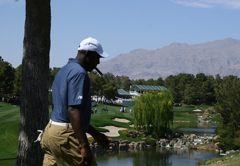 Michael Jordan walking on golf course with cigar at the Michael Jordan Celebrity Invitational in Las Vegas 2012