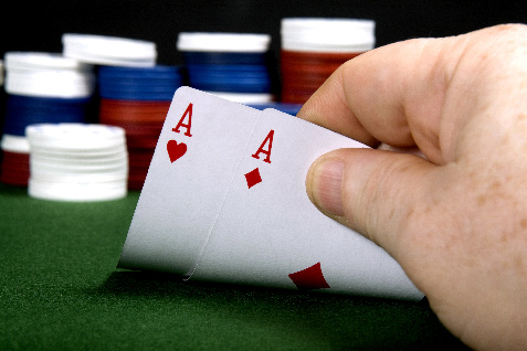 pair of aces in poker with poker chips